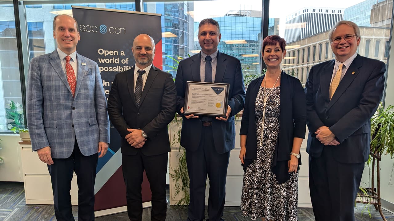 Alpesh Shah, Managing Director of IEEE SA, accepts a certificate of accreditation on behalf of IEEE SA and IEEE from Standards Council of Canada (SCC) staff.